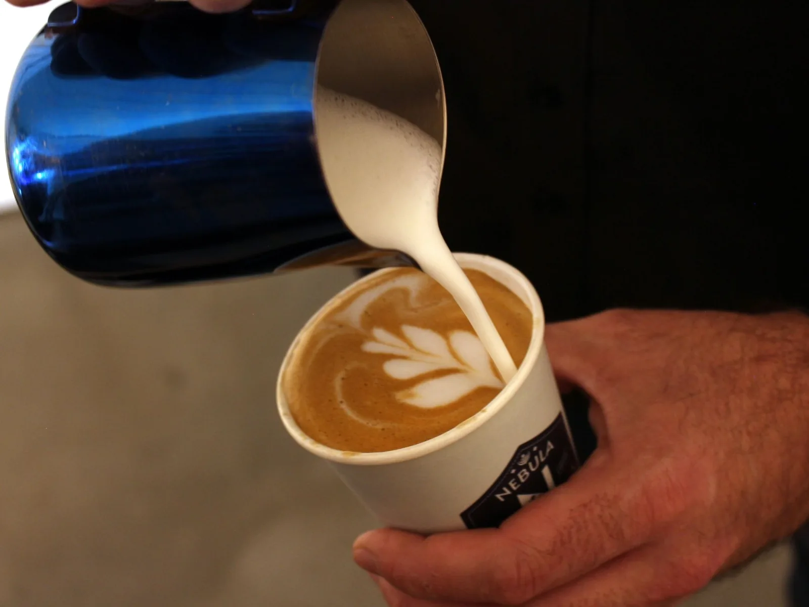 Skilled barista creating latte art for coffee catering service