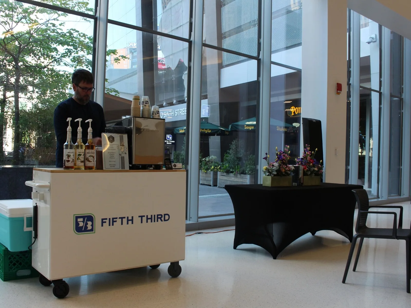 Professional barista serving at corporate office coffee event