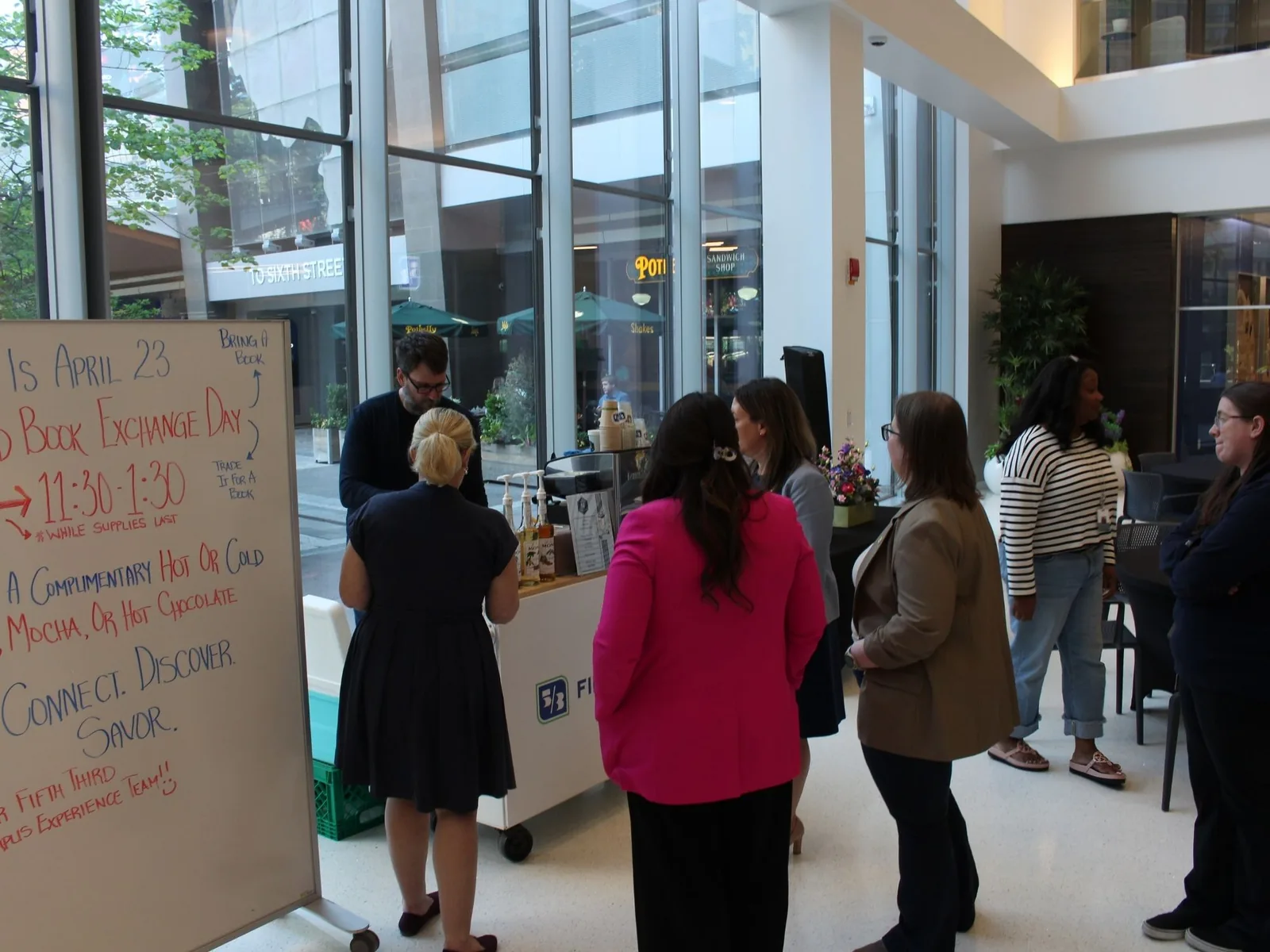 Employees enjoying mobile coffee cart service at work