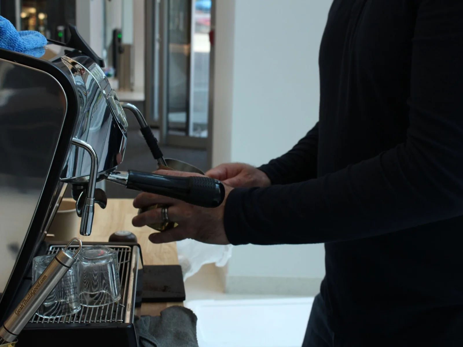 Skilled barista steaming milk for mobile coffee service