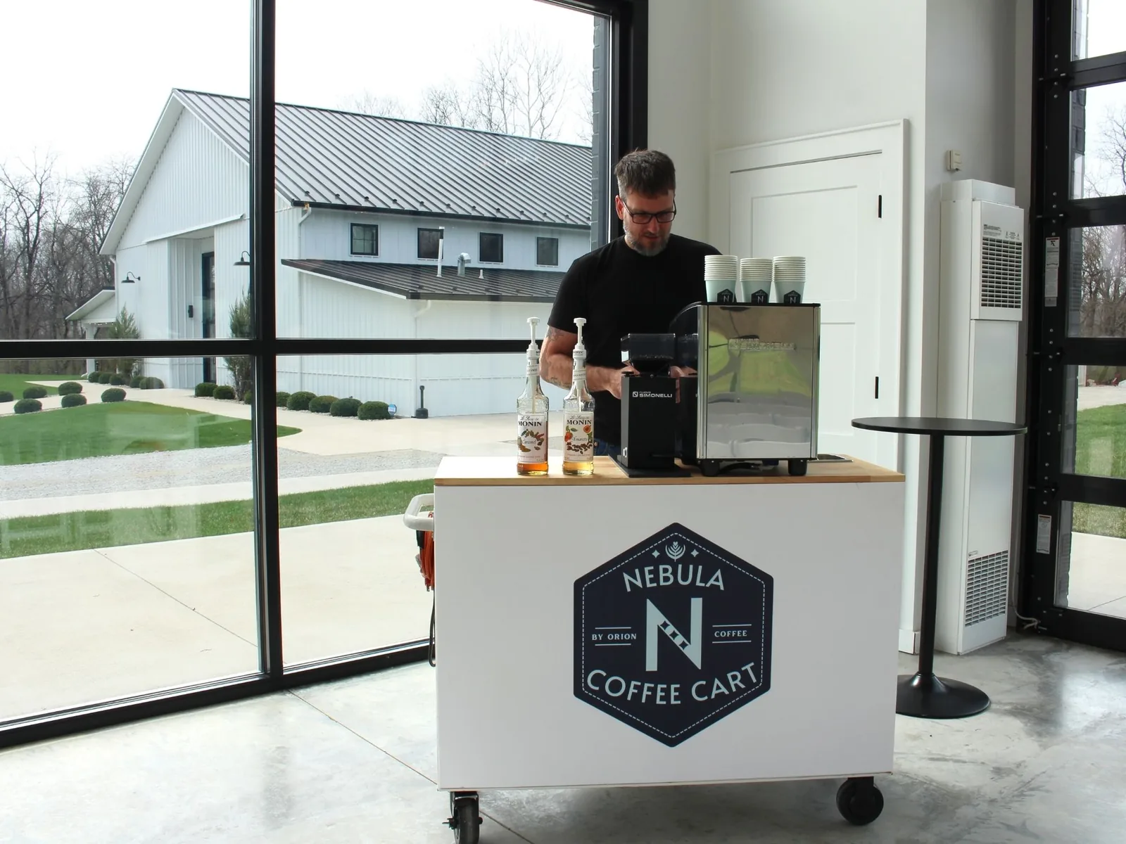 Professional barista serving espresso from the Nebula mobile coffee cart at an Ohio event venue